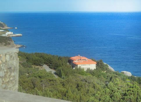 Panorama of the sea and a Park with trees, one luxury house on the beach, Sunny summer day, Crimea, Russia.