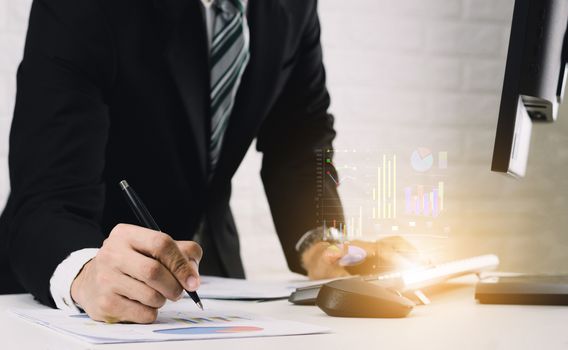 Business men work on the table Analyze graphs financial report in documents and computers.