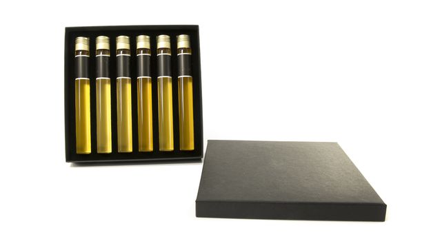samples of six different whiskeys as a tasting collection on white background