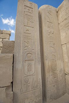 Hieroglypic carvings on wall columns at the ancient egyptian temple of Karnak in Luxor