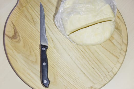 selective focus knife and cut dough on the wooden chopping board
