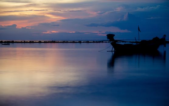 A Boat Silhouette in the night sea.