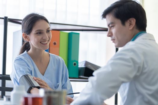 A doctor take care of sick patient woman at the hospital or medical clinic.