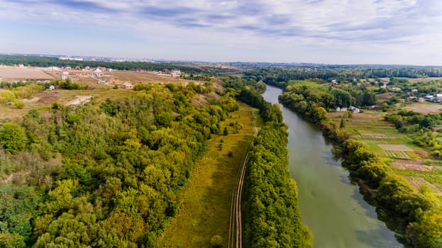 Beautiful view of the forest and the river in the city. Aerial view.