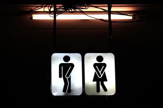 signs night bathroom, old toilet symbol male and female in the night background