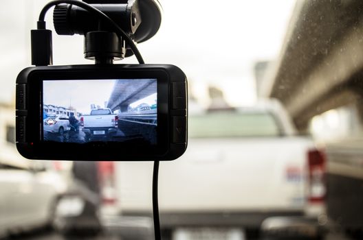 A camera in car has on and recording for the traffic jam in the morning.