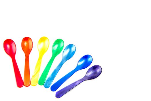 Multicolored spoons isolated on white background.
