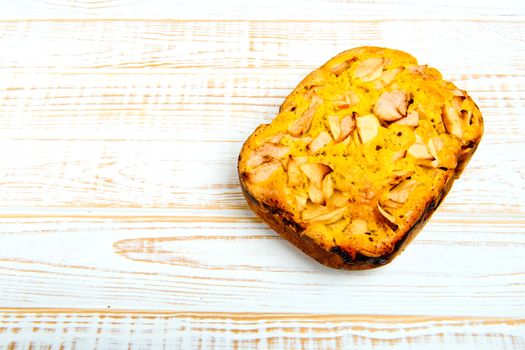 Fresh bakery. Baked pie with apples on white wooden background.