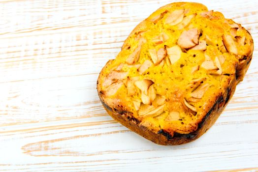 Fresh bakery. Baked pie with apples on white wooden background.