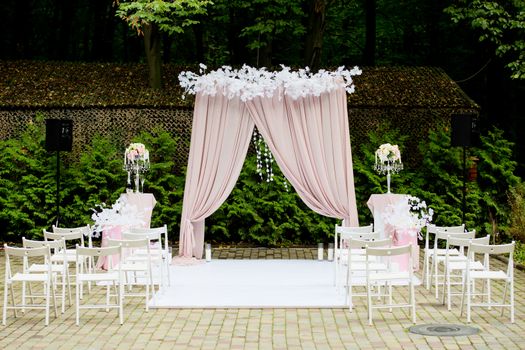 Arch for the wedding ceremony in a rustic style. Wedding decorations.