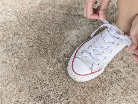 Shoe laces on the ground.