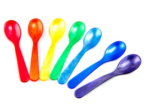 Multicolored spoons isolated on white background.