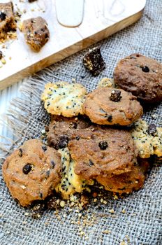 Chocolate Chip Cookies on brown linen napkin on white wood table in the dessert time.