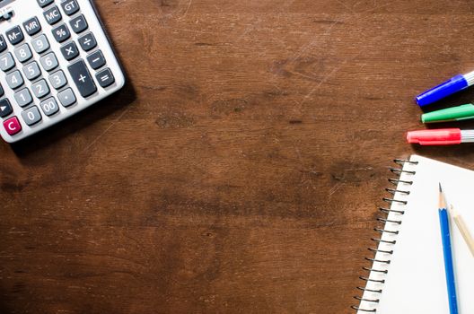 Note Writing and calculating on the wood table.