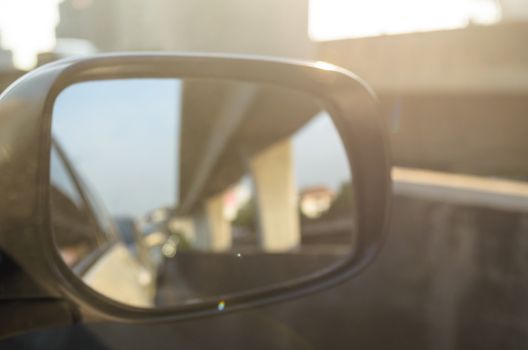 Car Side Mirror and looking back has traffic jam in the morning.