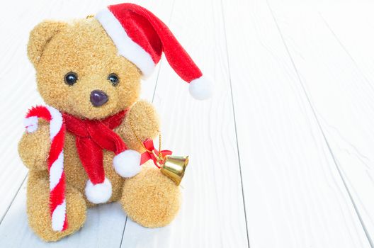 A Santa Bear Doll has already to celebrate the christmas and new year festival with wood background.