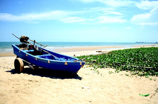 Old Wooden Boat on the beach at morning in summer season with hard light sunshine.