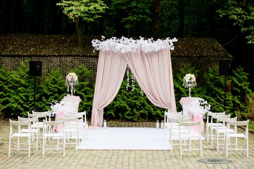 Arch for the wedding ceremony in a rustic style. Wedding decorations.