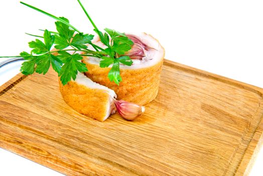 Pork belly with garlic and parsley on wooden board isolated on a white background.