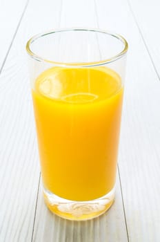 The Freshly Squeezed Orange juice on the white wood table