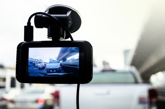 A camera in car has on and recording for the traffic jam with lighting of sunrise in the morning.