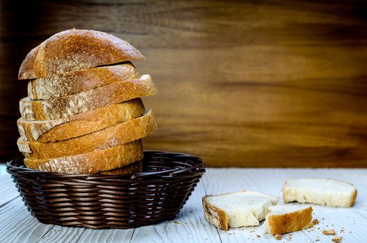 A Sliced Pain De Campagne Au Levain Bread in the wicker brown wood basket bowl.