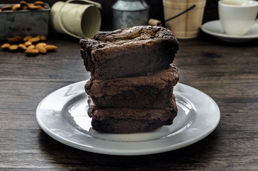 The Chocolate Brownie with Almonds and Coffee on the pallet wood has ready to served in the dessert time.