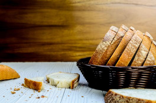A Sliced Pain De Campagne Au Levain Bread in the wicker brown wood basket bowl.