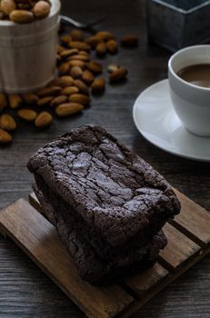 The Chocolate Brownie with Almonds and Coffee on the pallet wood has ready to served in the dessert time.