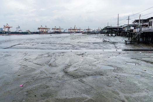 Transportation on the dirty sea with building city background and cloudy sky in Bangkok Thailand.