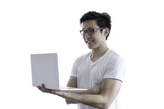 Asian handsome man with white shirt and orange eyeglasses has smile and happy when holding and working with computer laptop for goal and successful isolated on white background and clipping paths.