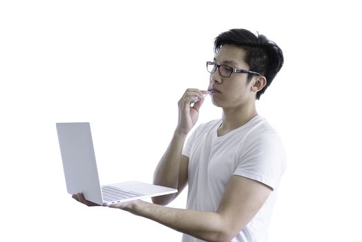 Asian handsome man with white shirt has wake up and  sleepy with tooth brush and working by holding laptop before going to start the work in the morning isolated on white background and clipping paths.