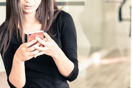 A asain businesswoman has checking email on mobile phone for working and contact with coustomer.