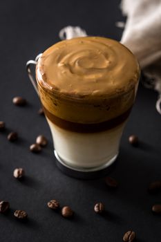 Creamy iced dalgona coffee on black background