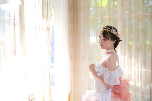 Asian Bride in white dress indoor room