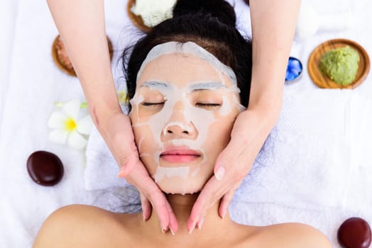 Portrait of beautiful asian people has masking with close up view and close up eyes and having hand massage in spa salon. Beauty, healthy, spa and relaxation concept.