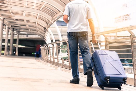 Asian adult tourist walking and travel with big blue bag to travel.