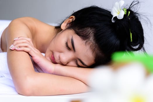 Portrait of beautiful asian people with close up view and close up eyes and having hand massage in spa salon. Beauty, healthy, spa and relaxation concept.