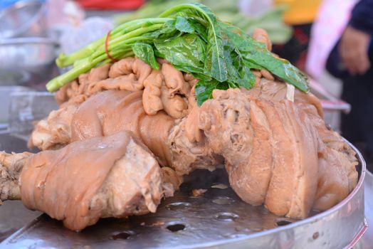 Braised pork knuckle in Chinese spices Topped with kale