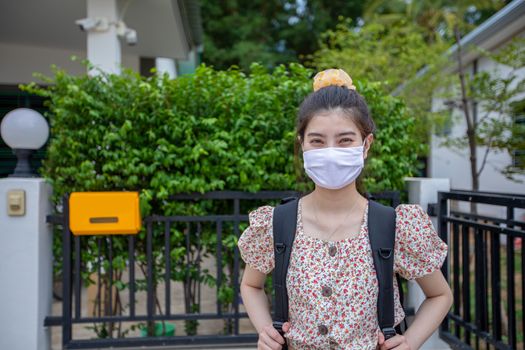 Asian women Smiling behind wearing protection mask on face for protection air pollution, particulates and for protection flu virus, influenza, coronavirus at city