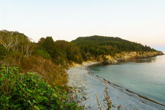 Sunset view of shore and ocean in the south sector of Forillon National Park, Gaspe Peninsula, Quebec, Canada