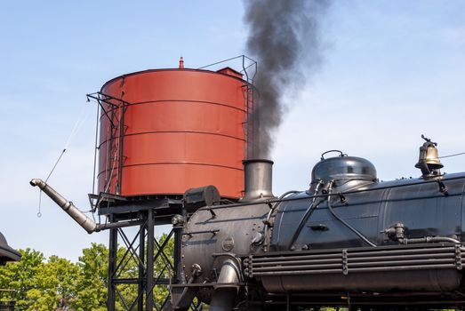 An old train with smoke coming out of its chimney