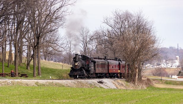 An old train in the middle of leafless trees