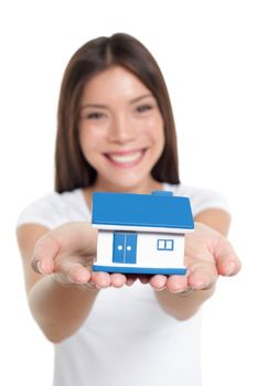 Real estate house market buying home insurance concept. Happy Chinese woman holding small toy home for protection, banking, mortgage, savings, ownership.