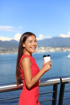 Happy multiethnic business woman enjoying her morning coffee at work break in beautiful nature view in vancouver city, downtown. Urban lifestyle, businesspeople working in coal harbour.