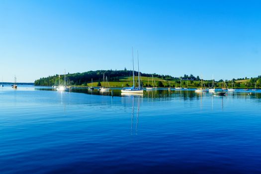 Morning view of boats and a green hill in Lunenburg Harbor, Nova Scotia