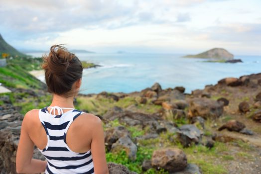 Hawaii travel woman tourist looking at makapuu lookout view of Waimanalo beach.