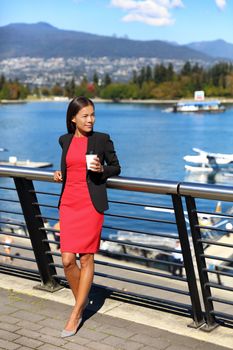 Urban people lifestyle. Businesspeople. Businesswoman enjoying coffee break at view of Vancouver harbor, modern city living.