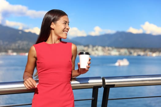 Happy multiethnic business woman enjoying her morning coffee at work break in beautiful nature view in vancouver city, downtown. Urban lifestyle, businesspeople working in coal harbour.
