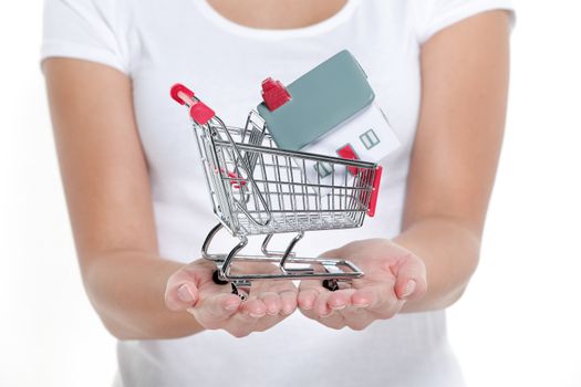 Real estate shopping buying a new house concept. Woman showing miniature small toy model on open hands. Isolated on white background.